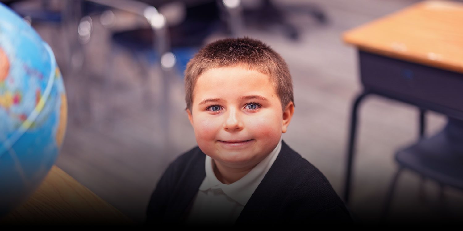 Student smiling in a classroom