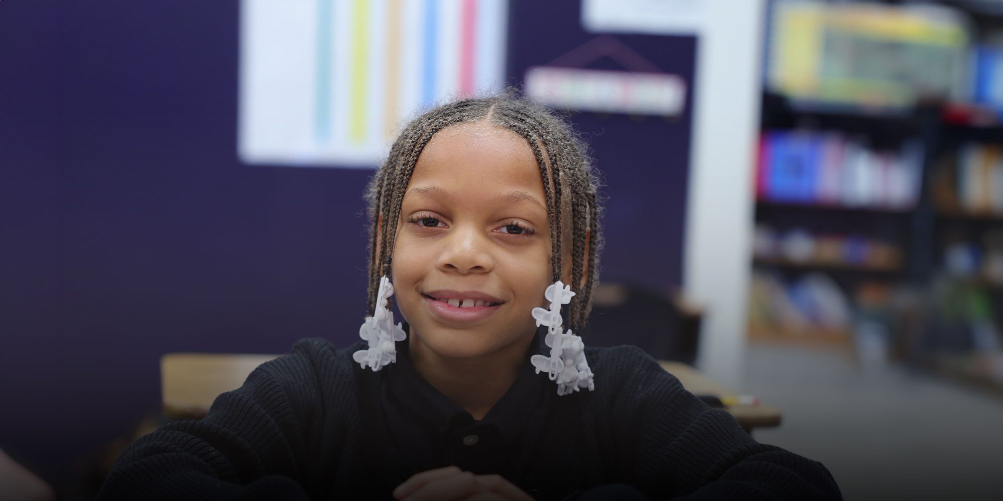 Smiling student sitting at desk